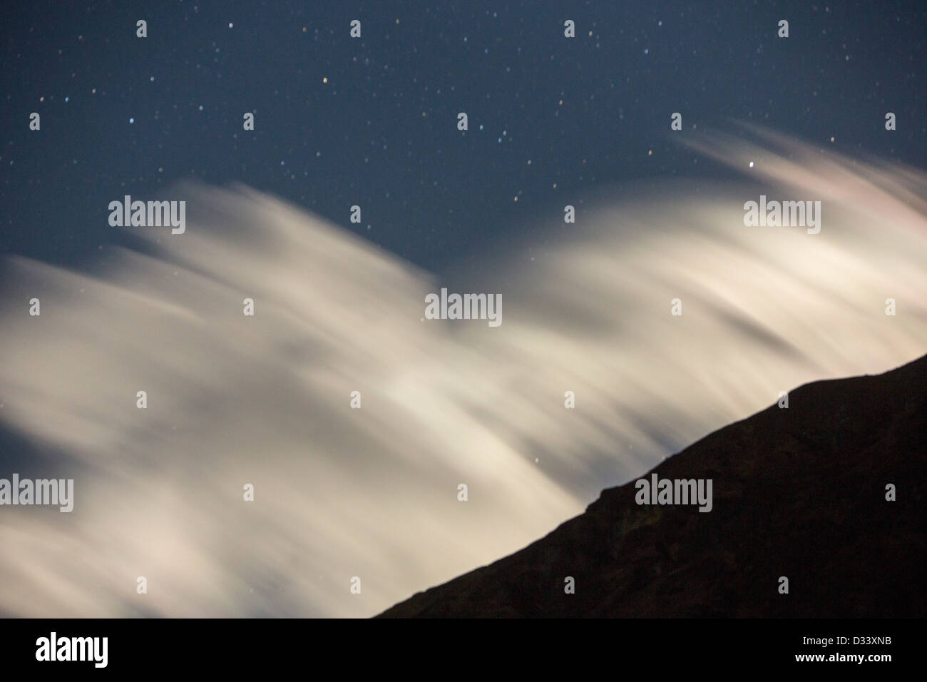 The night sky over a peak in the Annapurna Sanctuary, Himalayas, Nepal. Stock Photo