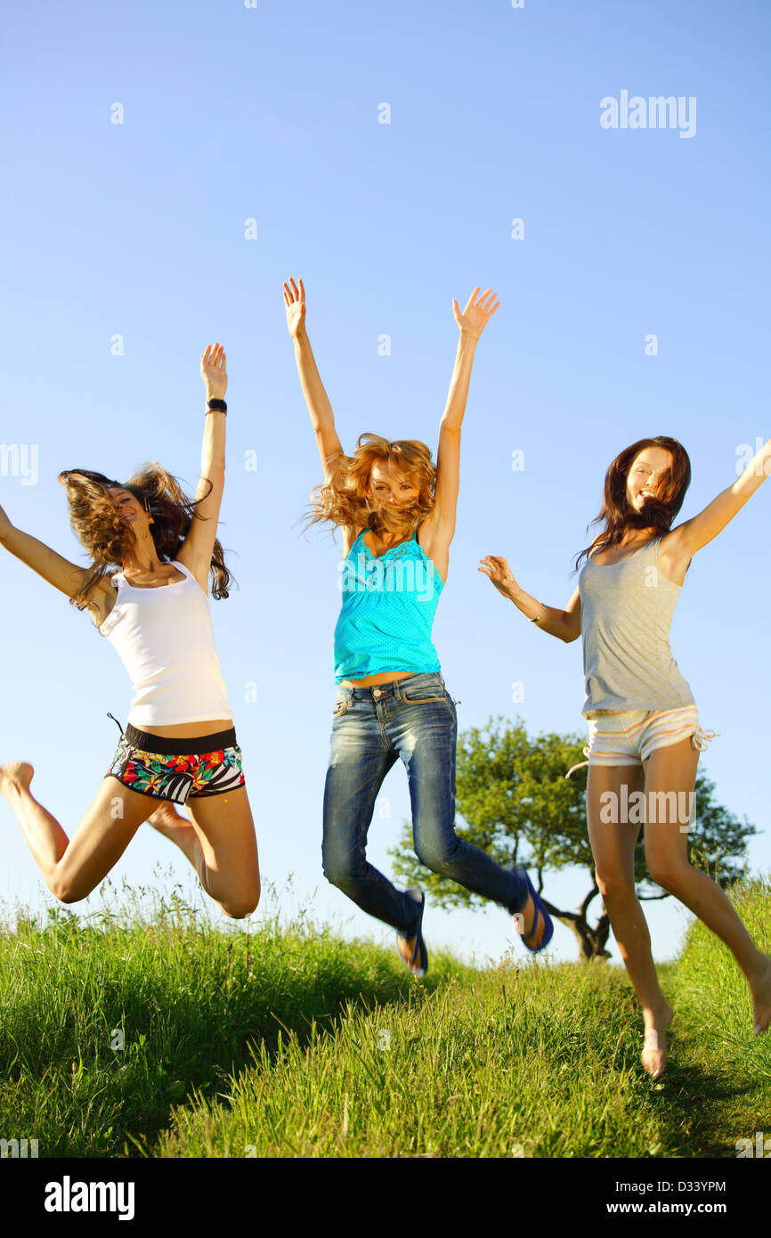 Smiley woman jumping hi-res stock photography and images - Alamy