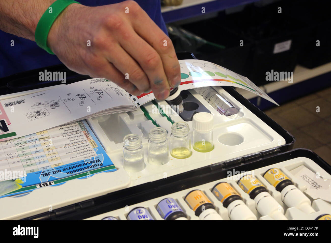 Man Using Water Testing Kit In Maidenhead Aquatics Shop England Stock