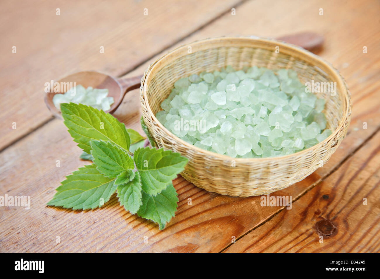 Green bath salt in a small straw bowl Stock Photo