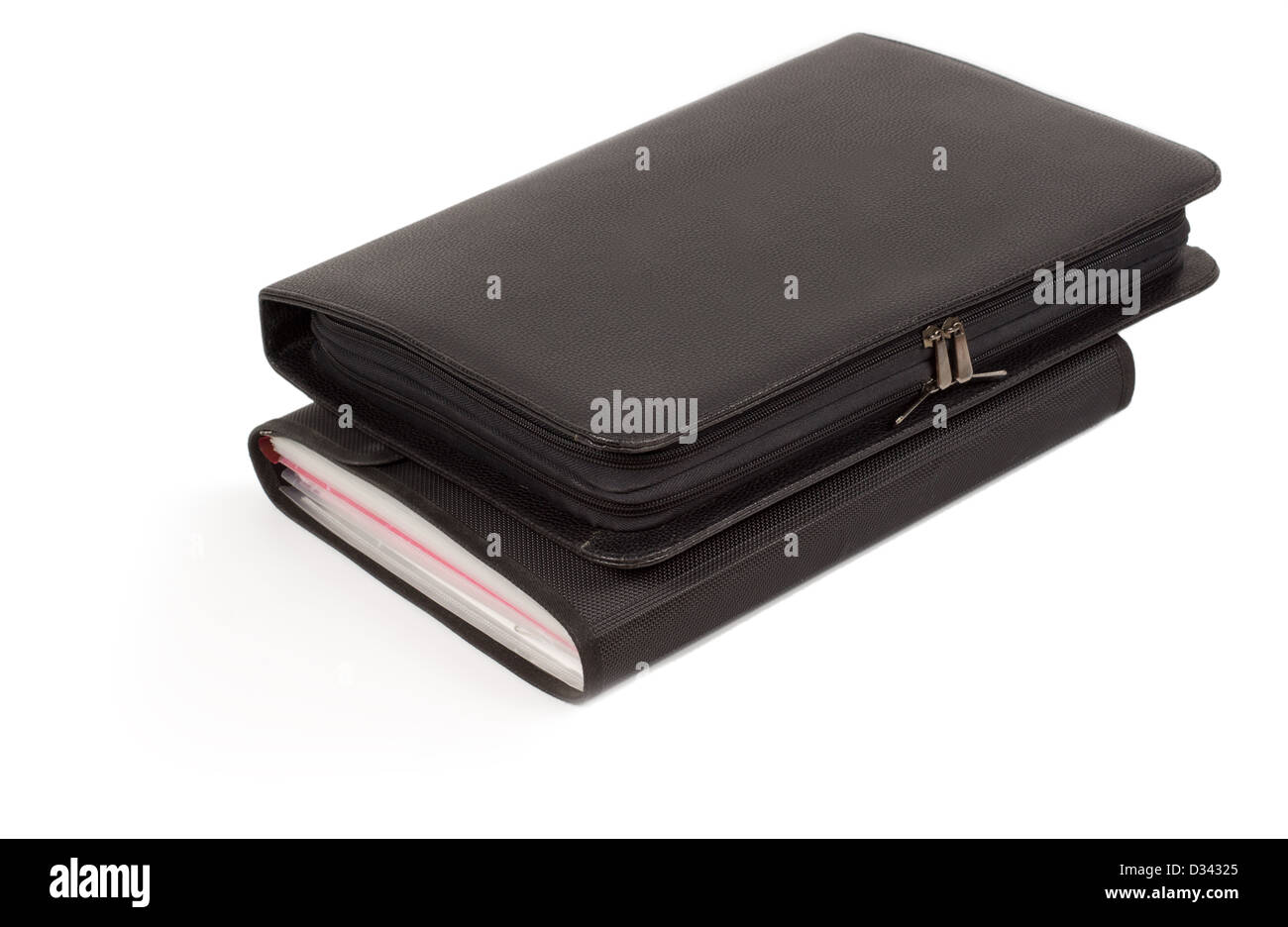 Two different closed black leather diaries or journals stacked one on top of each other isolated on a white background Stock Photo