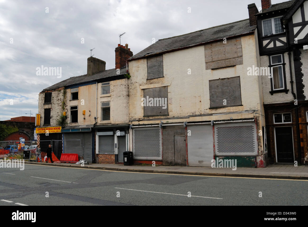 Run down semi derelict buildings in Warrington town centre with boarded up shops. NOW DEMOLISHED - currently a car parking area Stock Photo