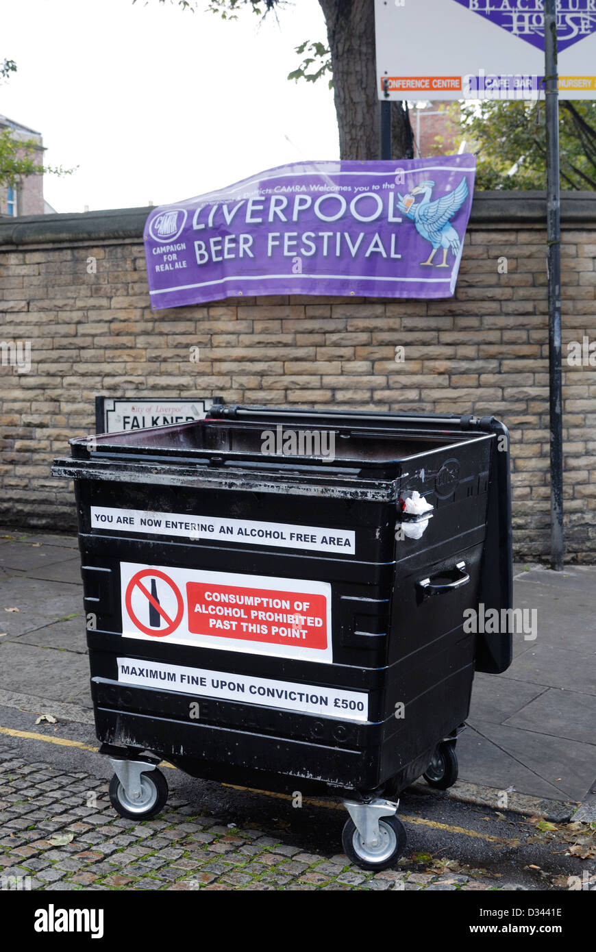 Wheelie bin covered with warning signs stating it is an alcohol free area - outside Liverpool Beer Festival! Stock Photo