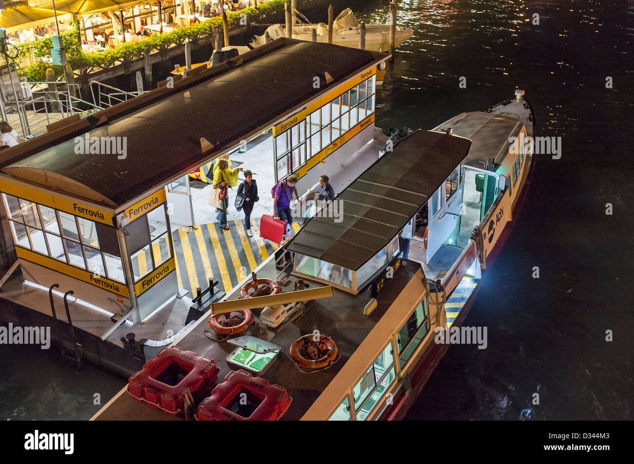 Water Bus Stop on the Grand Canal Venice at Night Stock Photo