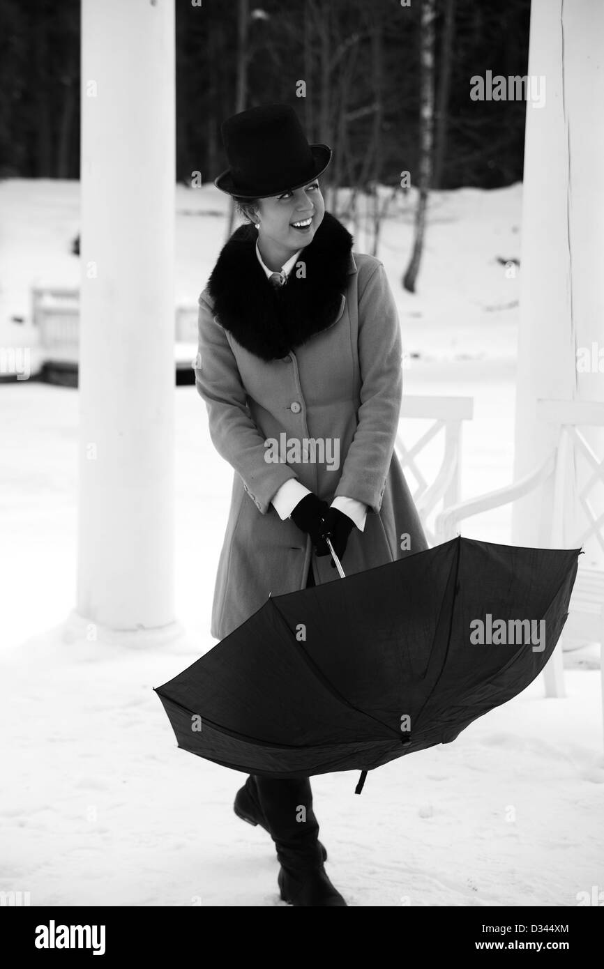 Shaded woman try close black umbrella on walk Stock Photo Alamy