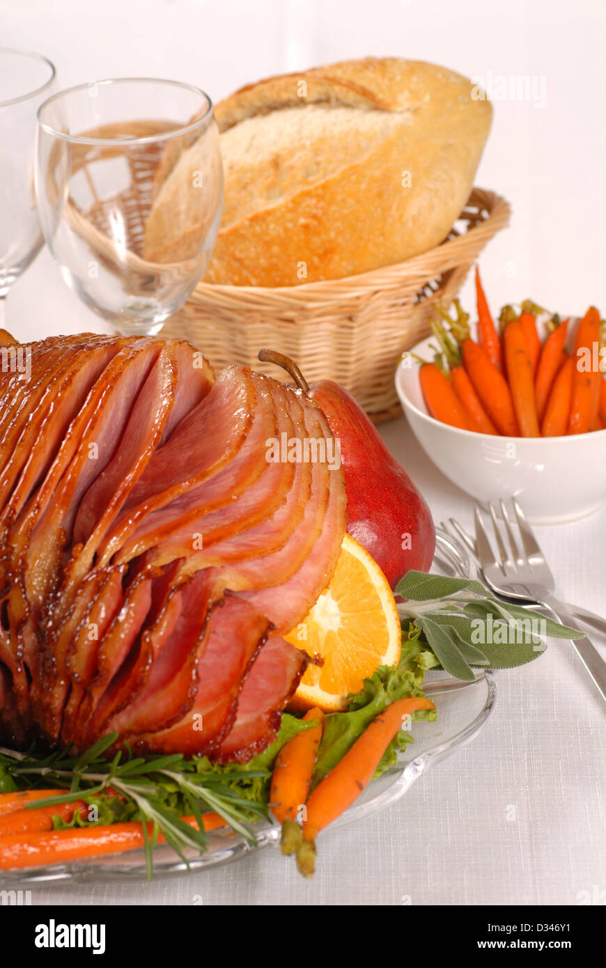 Brown sugar and honey glazed Easter ham with fruit and carrots Stock