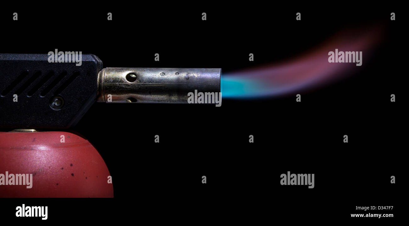 Blowtorch with blue flame on black background Stock Photo