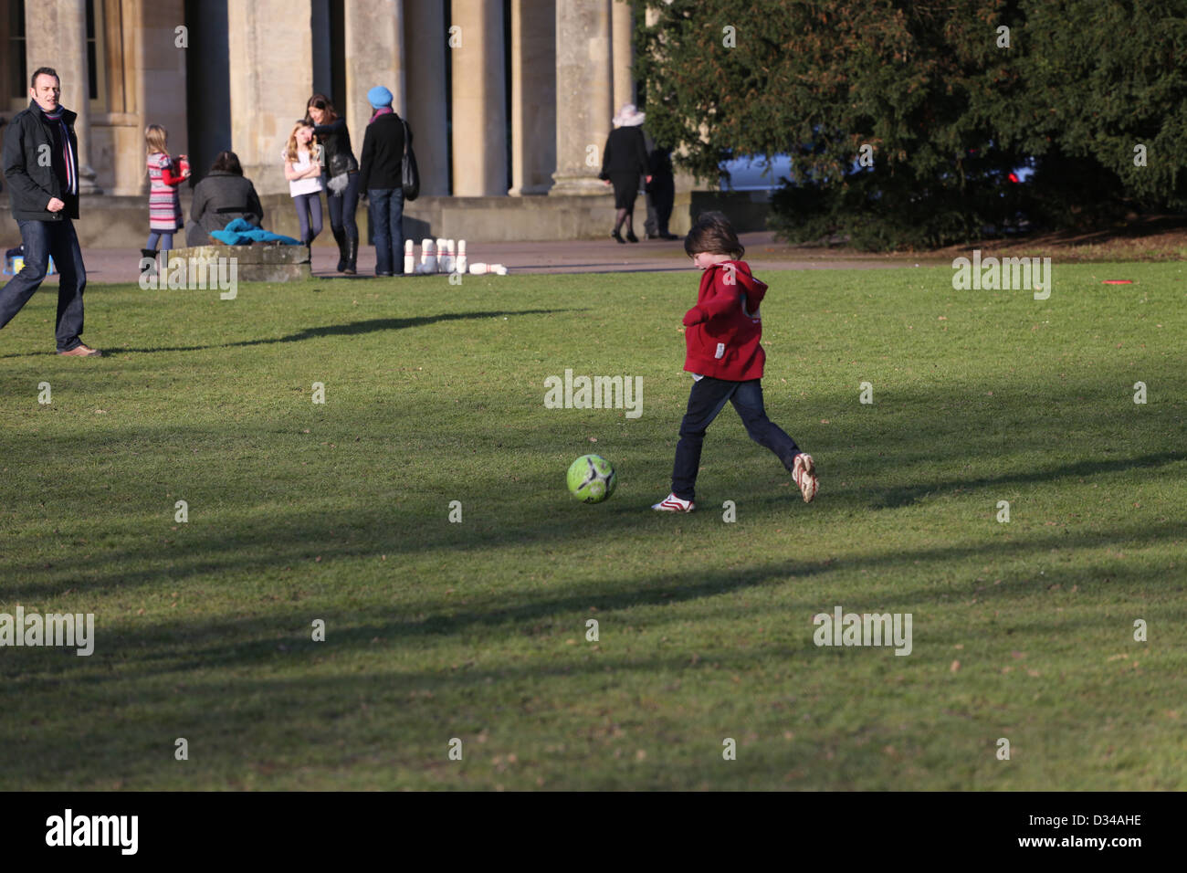 Father And Son Playing Football At the Pittville Pump Room Pleasure Gardens Cheltenham Gloucestershire England Stock Photo