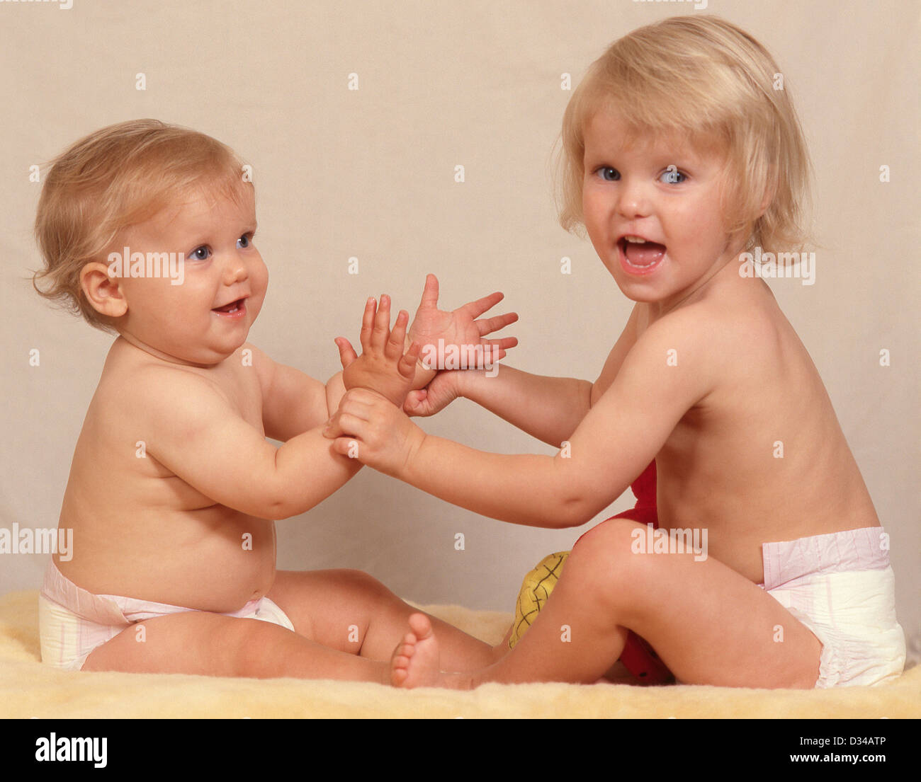 Young female toddlers (sisters) playing together, Winkfield, Berkshire, England, United Kingdom Stock Photo