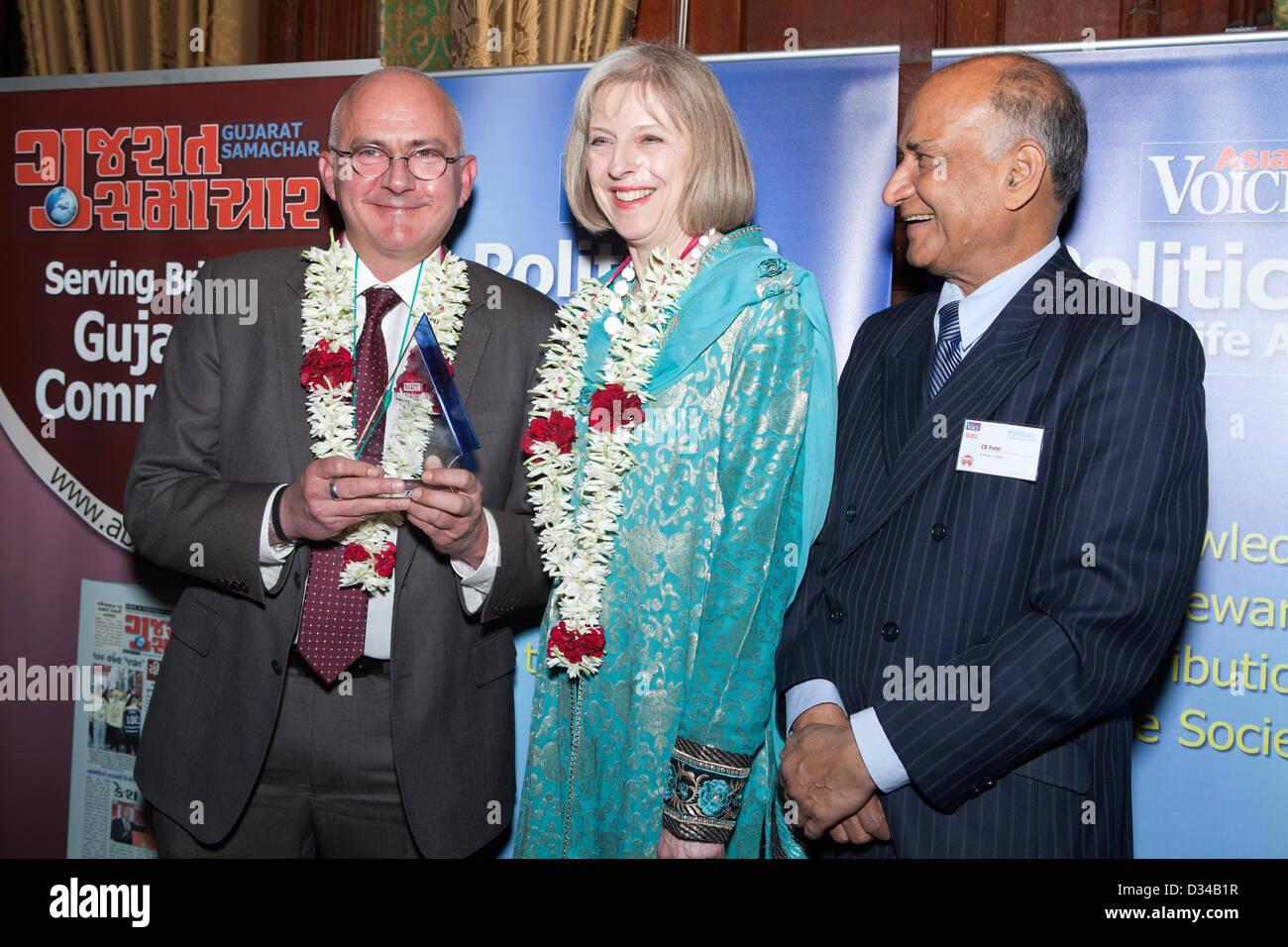 London, UK. 7th February 2013. On the right is Andrew Norfolk with an award in honour of being the Reporter of the Year at the POlitical and Public Life Awards 2013. In the center is the Cabinet Minister Rt Hon Theresa May, Member of Parliament and on the right is C B Patel, Managing Director, Asian Voice newspaper. Stock Photo