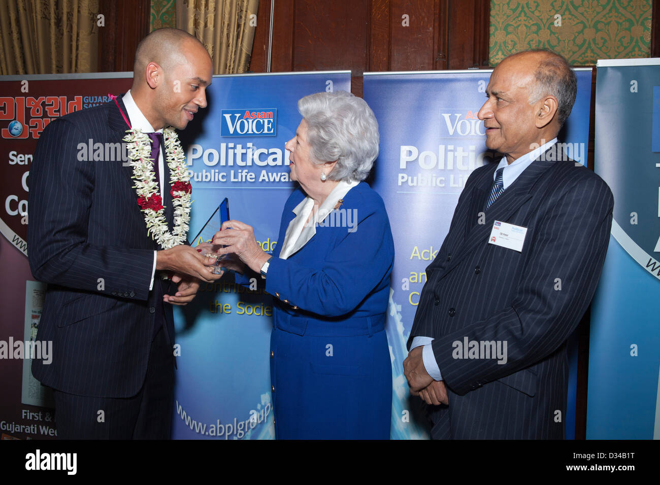London, UK. 7th February 2013. On the right is Shadow Cabinet Secretary, Chuka Umunna, Member of Parliament being presented with an award for being The Shadow Cabinet Minister of the year by Guest of Honour, Baroness Betty Boothroyd, Former Speaker of the House of Commons at the Political and Public Life Awards 2013. On the right is C B Patel, Managing Director, Asian Voice newspaper. Stock Photo