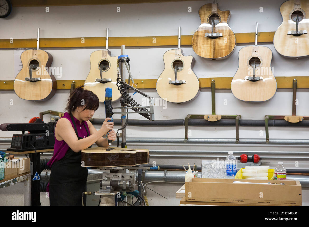 El Cajon, California - Workers make guitars at the Taylor Guitars factory. Stock Photo