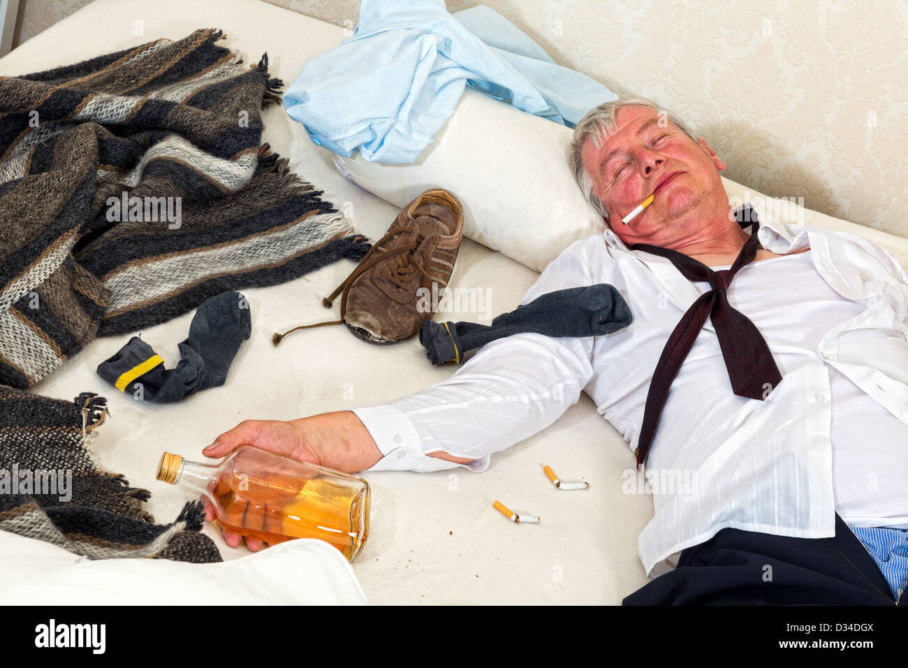 Drunken alcoholic sleeping in a messy bed Stock Photo Alamy