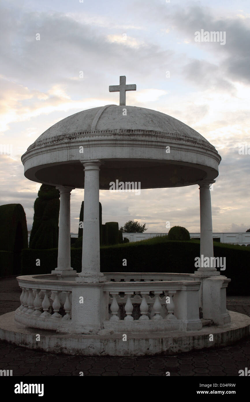 A dome with a cross covering a grave site in the cemetery in Tulcan, Ecuador Stock Photo