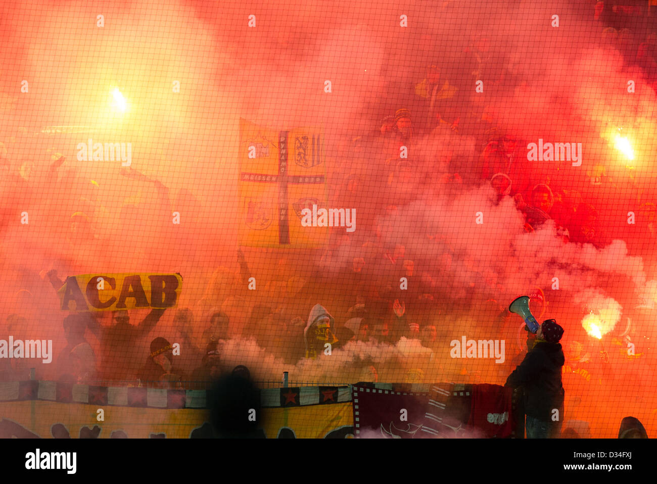Dresden fans light up flares during the Bundesliga second devision match between 1. FC Kaiserslautern and SG Dynamo Dresden at Fritz-Walter Stadium in Kaiserslautern, Germany, 08 February 2013. Photo: Uwe Anspach Stock Photo