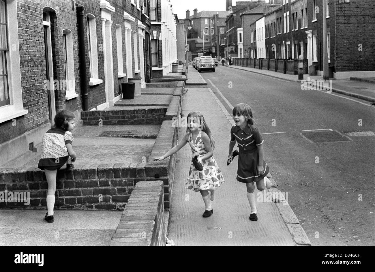 Children, girls playing safely in the street hopping on one foot. Elephant and Castle, SE London. 1970s Uk 1975 HOMER SYKES Stock Photo