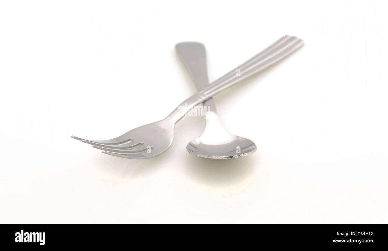 Spoon and fork utensils on white background Stock Photo