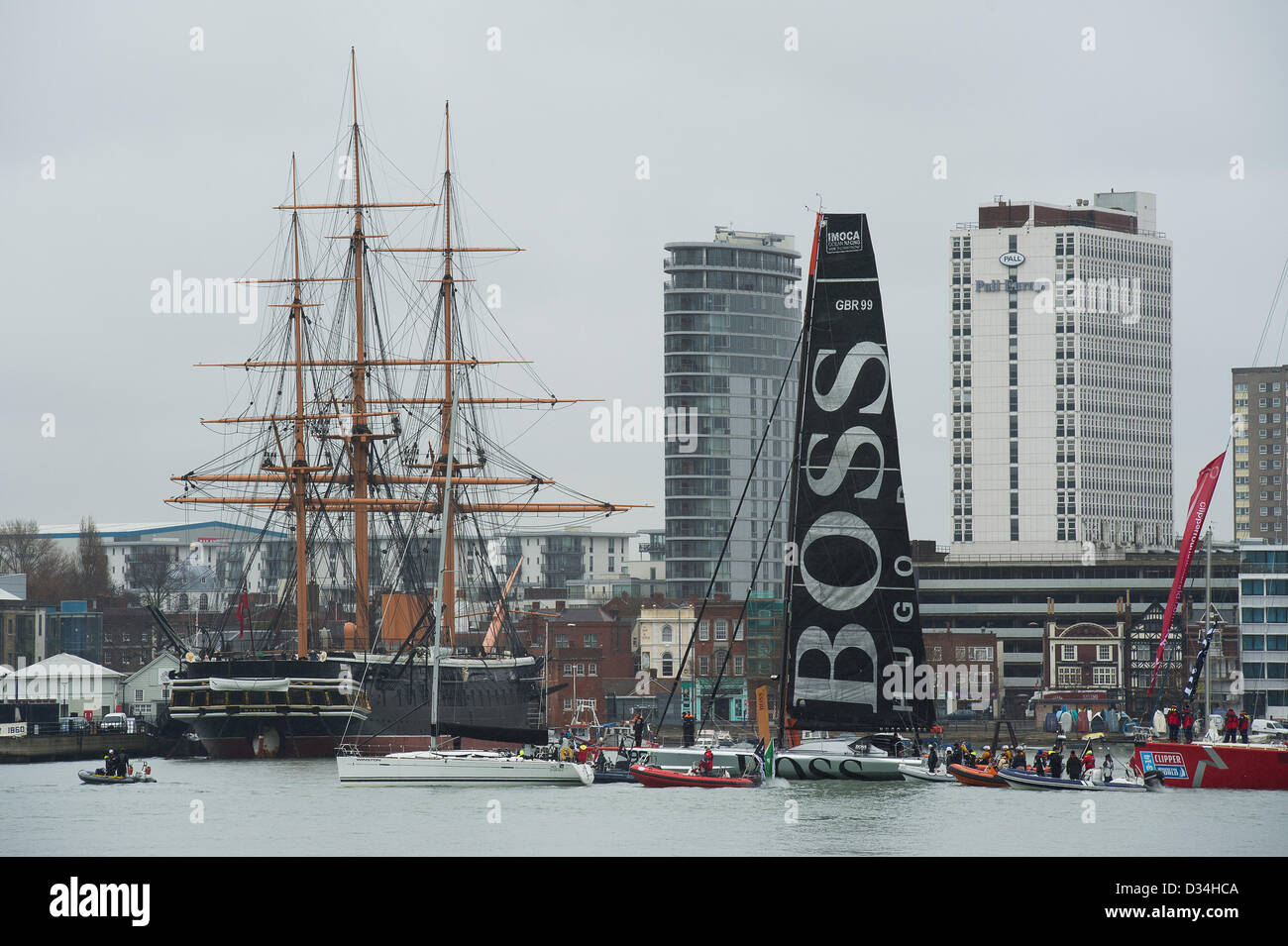 Alex Thomson skipper of Hugo Boss navigates past Portsmouth landmarks en-route to Haslar Marina Stock Photo