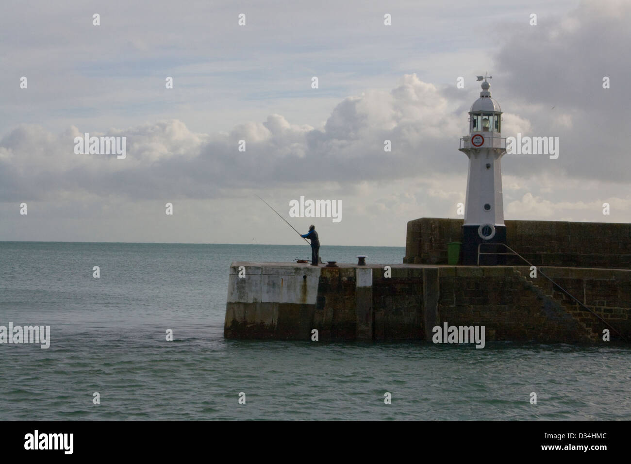 Harboar wall with lighthouse Mevageissey Cornwall Stock Photo