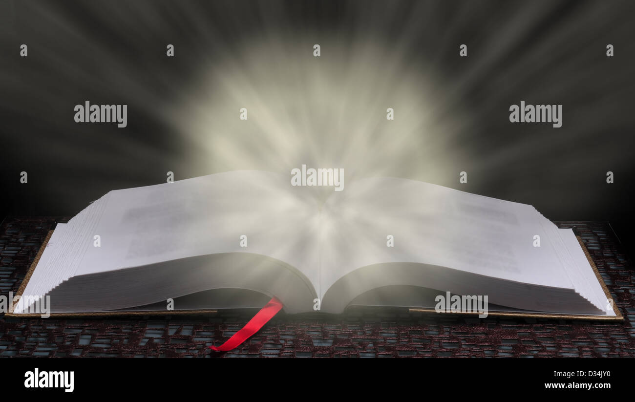 Wisdom and education concept with bright light glowing from book to signify learning Stock Photo