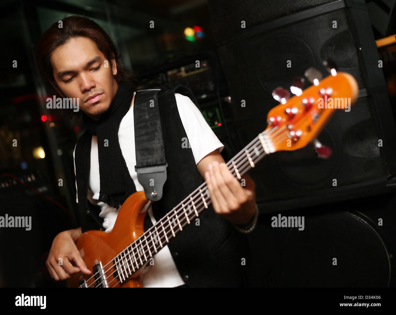 Young musician at an alive concert in a night club 