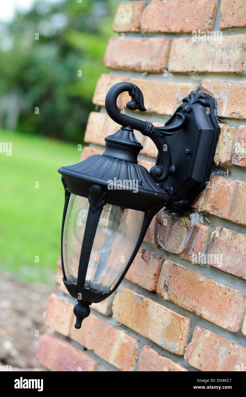 A light fixture on the exterior of a brick house Stock Photo Alamy