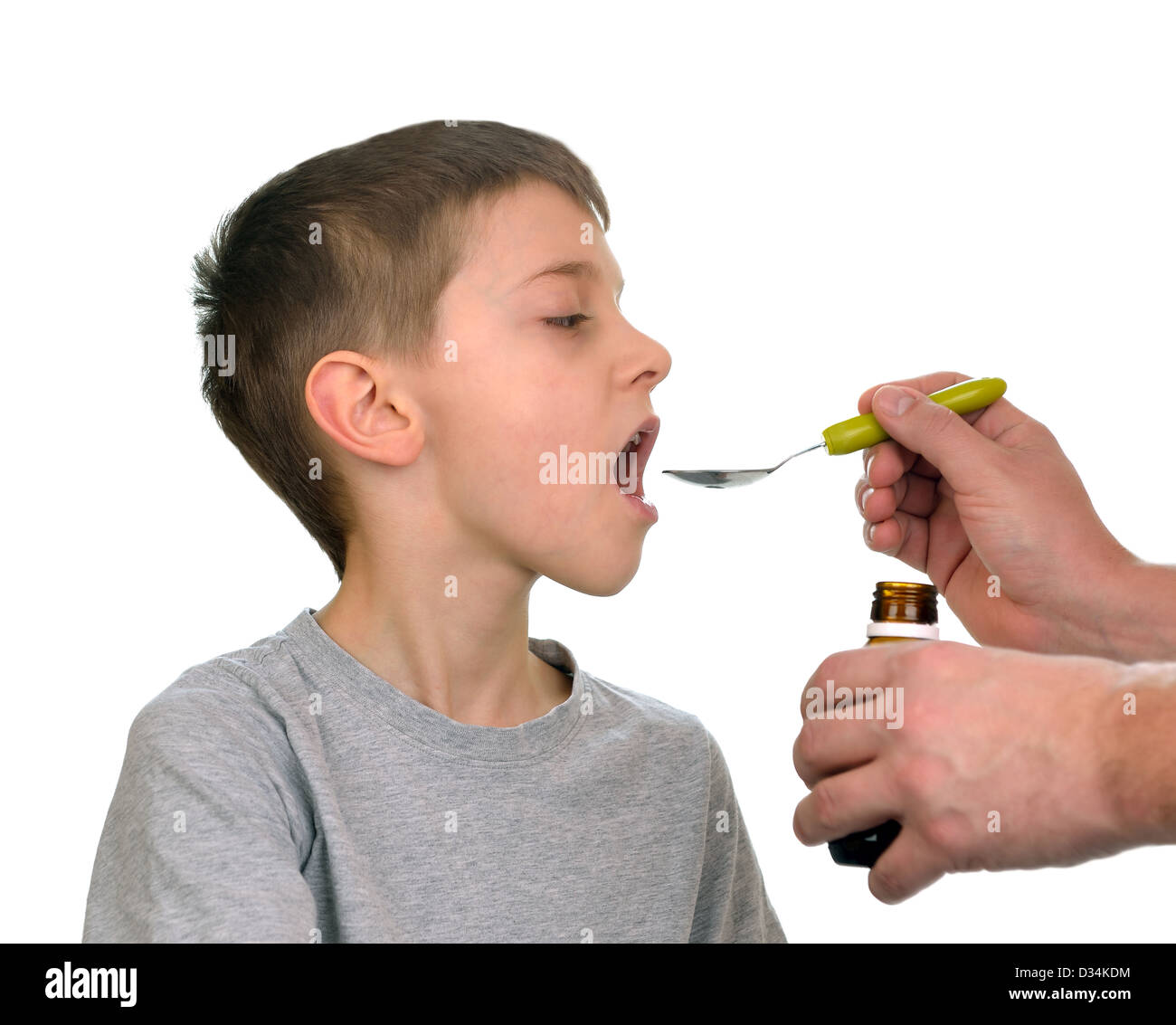 Father giving his son syrup because of the flu Stock Photo