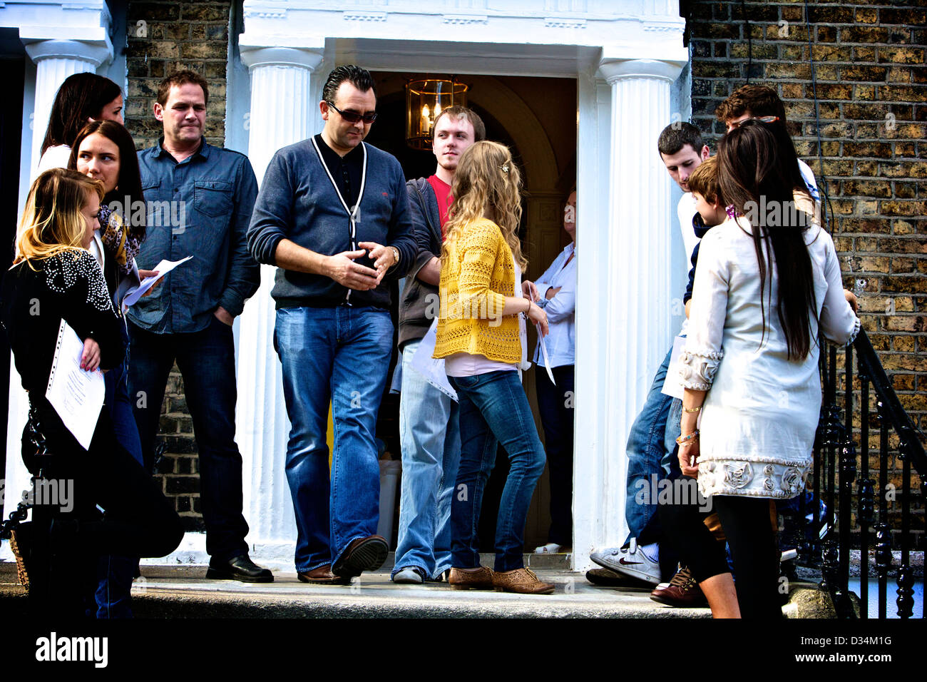 young people hanging around a doorway Stock Photo