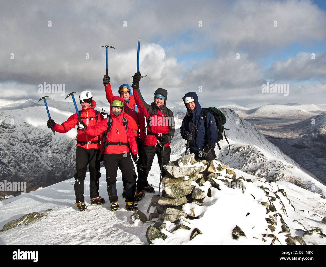 A group of winter mountaineers on the summit of Buachaille Etive Beag in Glencoe in Scottish highlands Scotland UK Stock Photo