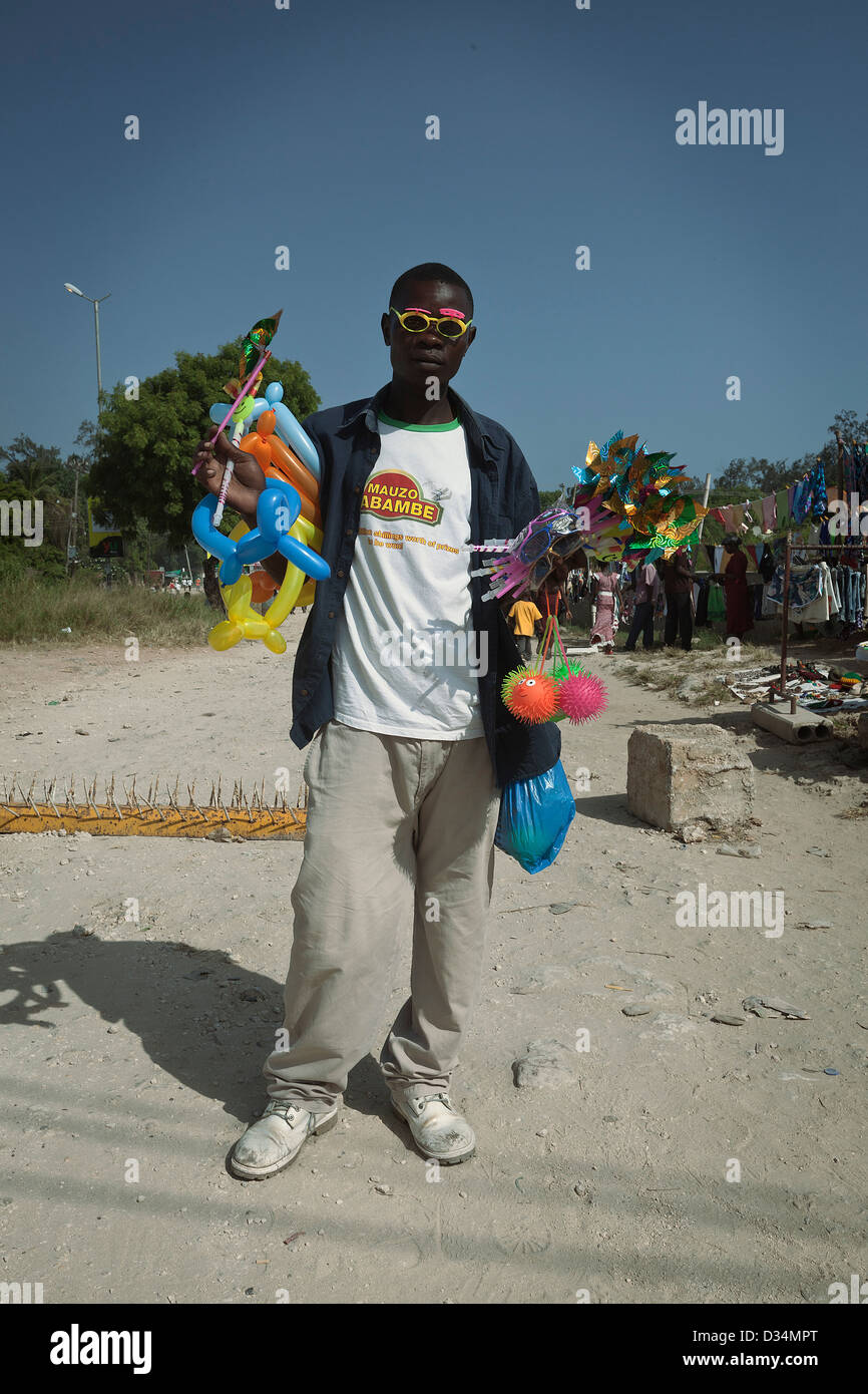 Street vendor sells toys for kids while wearing outlandish suglasses Stock Photo