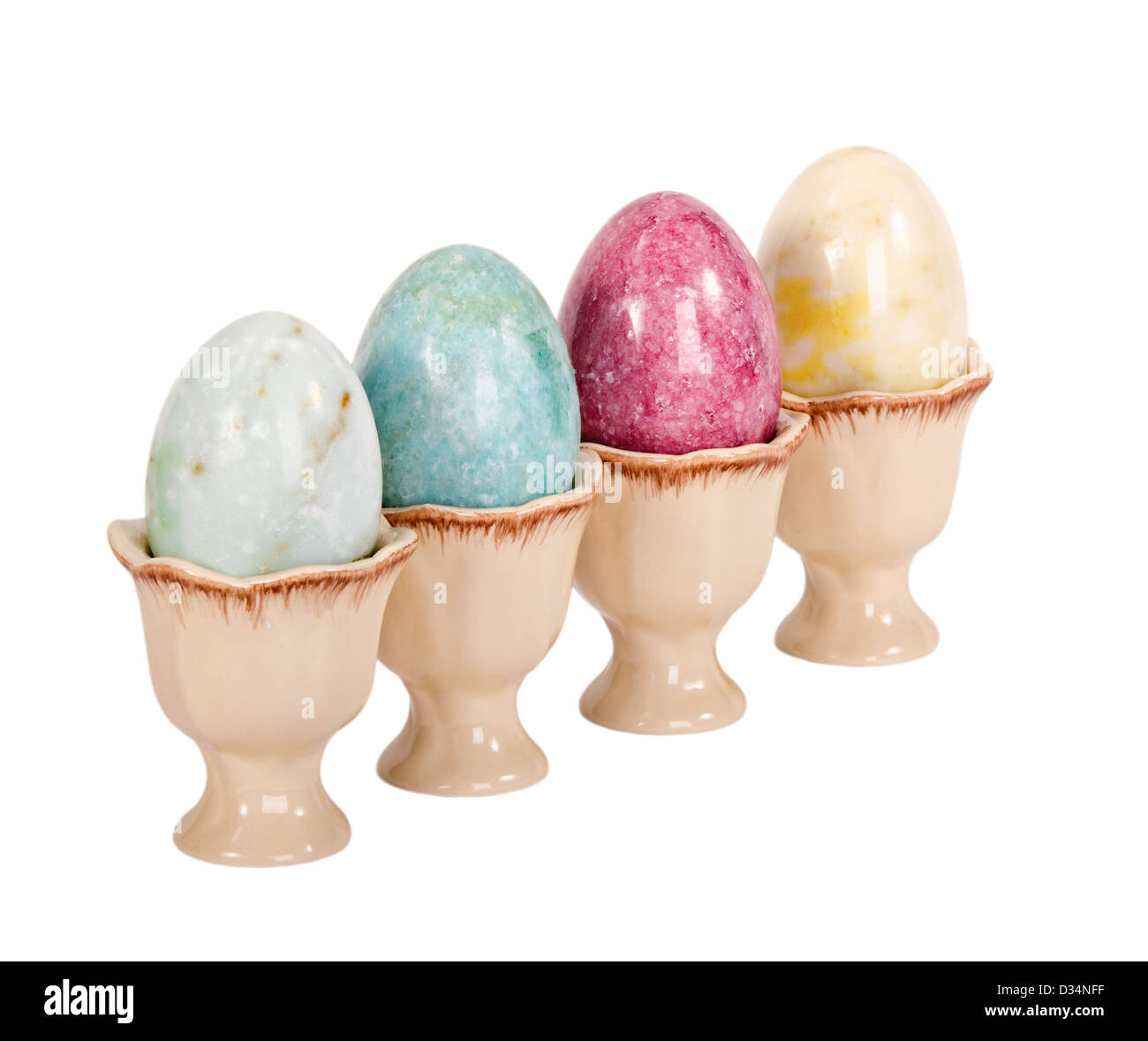 Marble Easter eggs in egg cups isolated over white Stock Photo