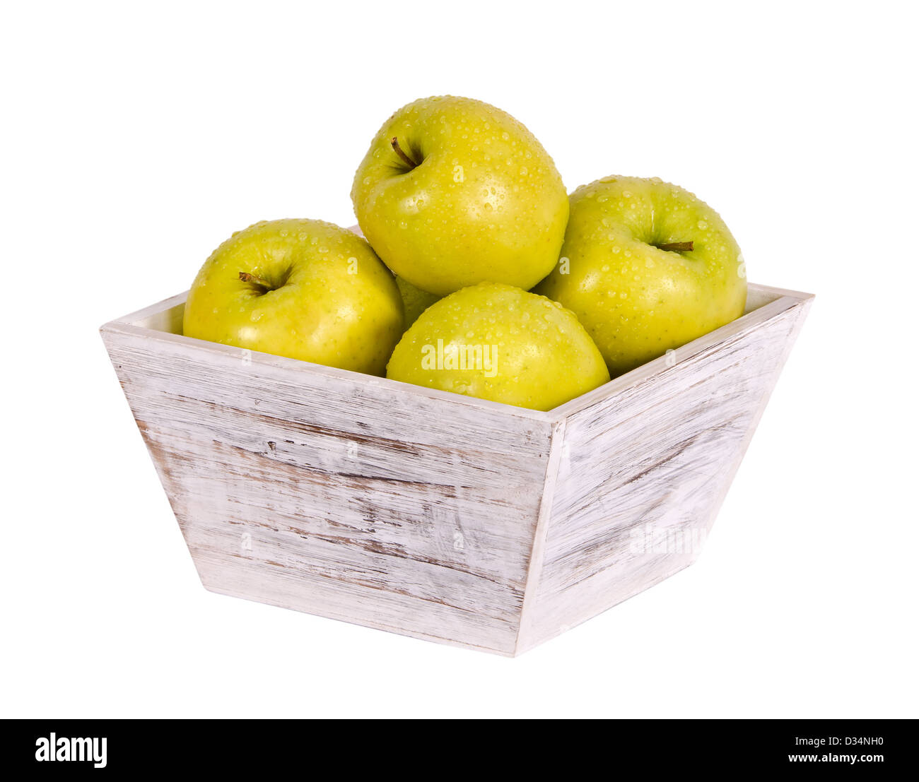 Golden delicious apples in white wooden container isolated over white Stock Photo