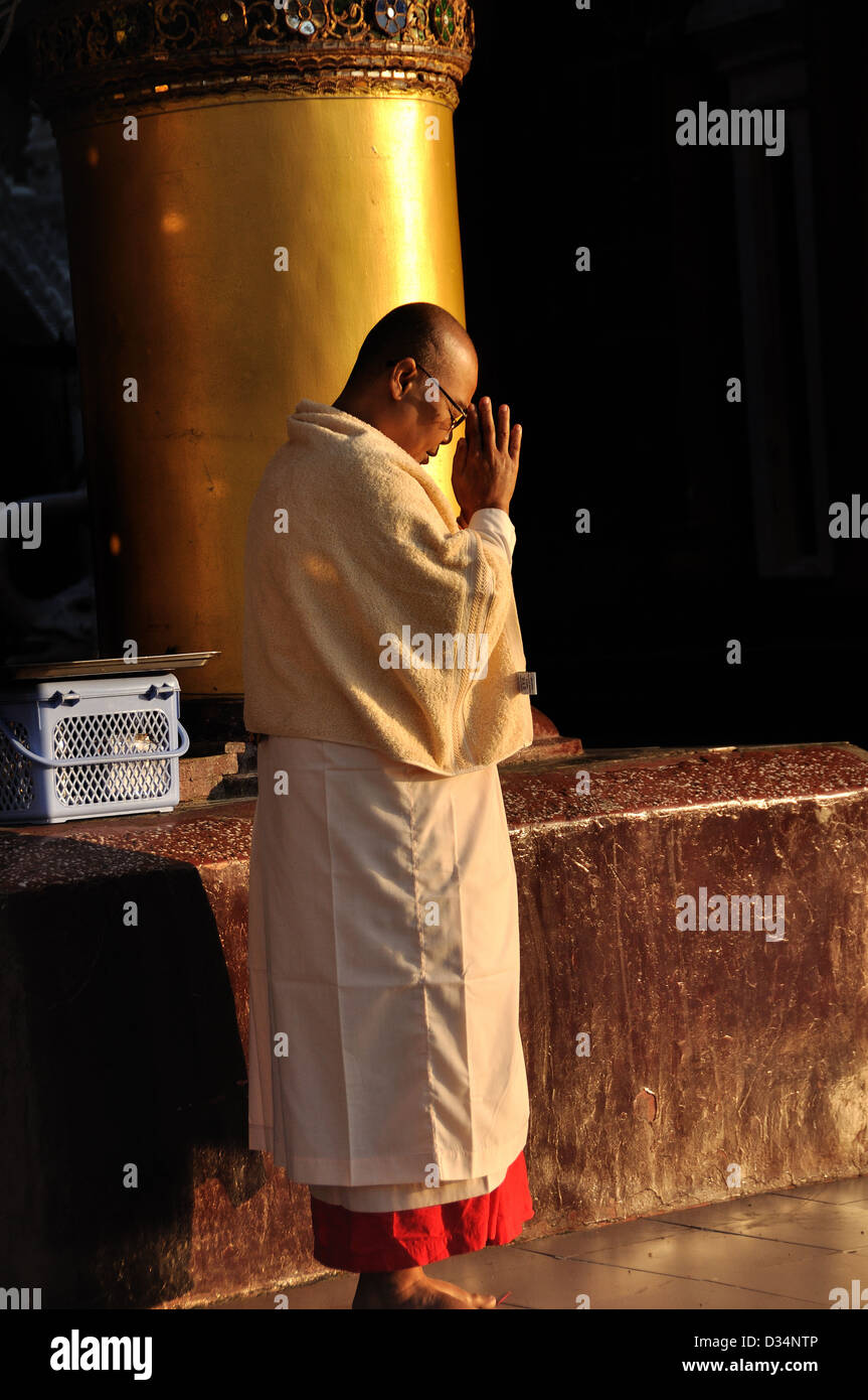 Buddhist Monk Praying at the Shwedagon Pagoda Stock Photo