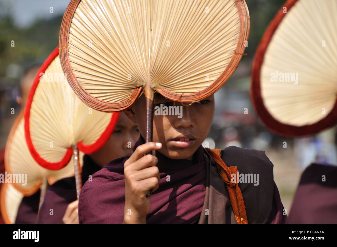 Novice Buddhist Monks Use Parasols to Give Shade From the Sun Stock Photo