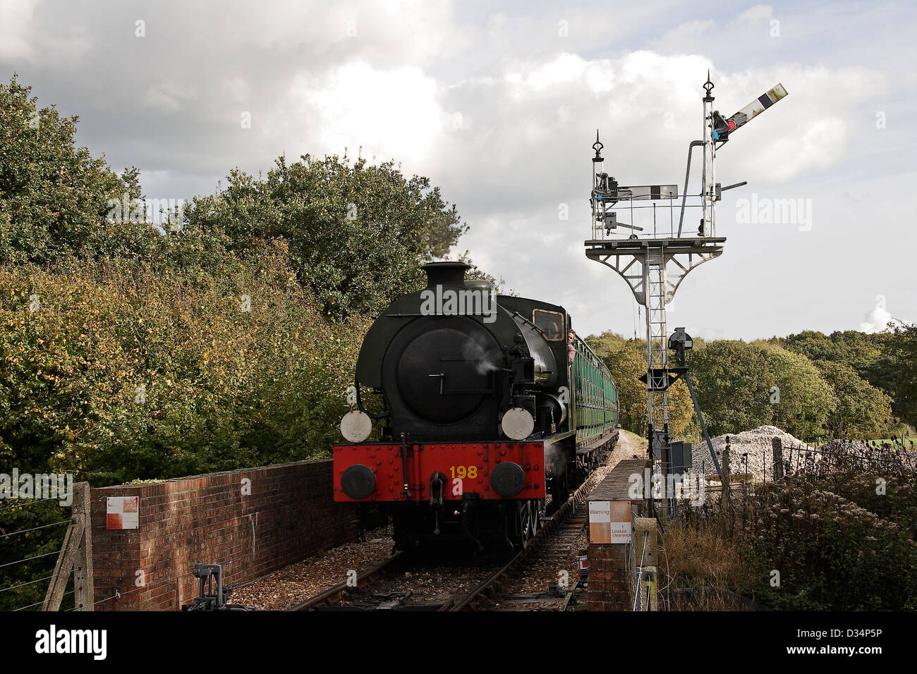 Preserved steam train running on track Isle of Wight steam railway Isle of Wight Hampshire