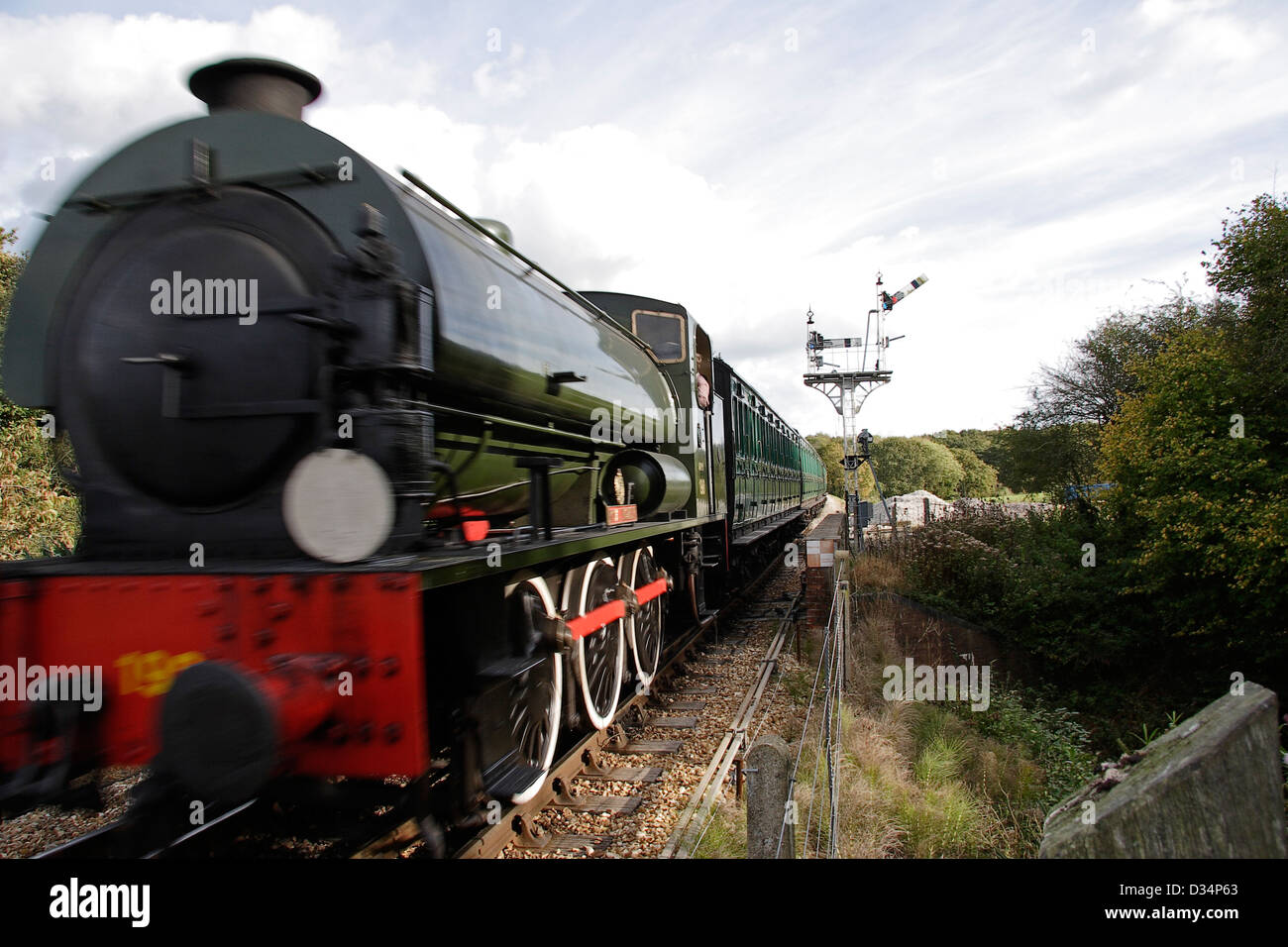 Preserved steam train running on track Isle of Wight steam railway Isle of Wight Hampshire