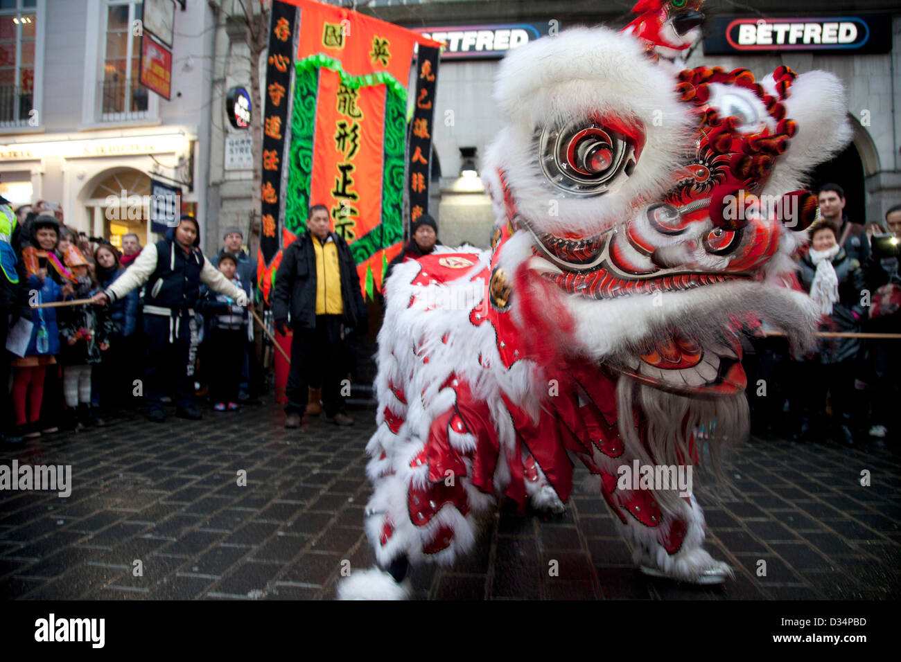 London, UK. Saturday 9th February 2013. To celebrate the Chinese New Year of the Snake, a dragon dance takes place on Gerrard Street in London's Chinatown. Local community come out in celebration as the dragon visits different restaurants to bless them for a prosperous year ahead. Credit:  Michael Kemp / Alamy Live News Stock Photo