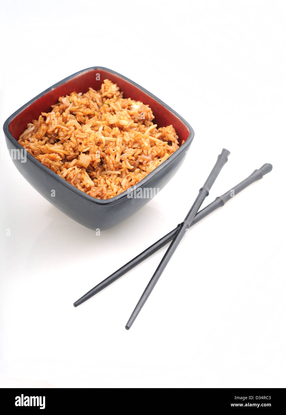 Chinese food or fried rice in red bowl with chopsticks Stock Photo