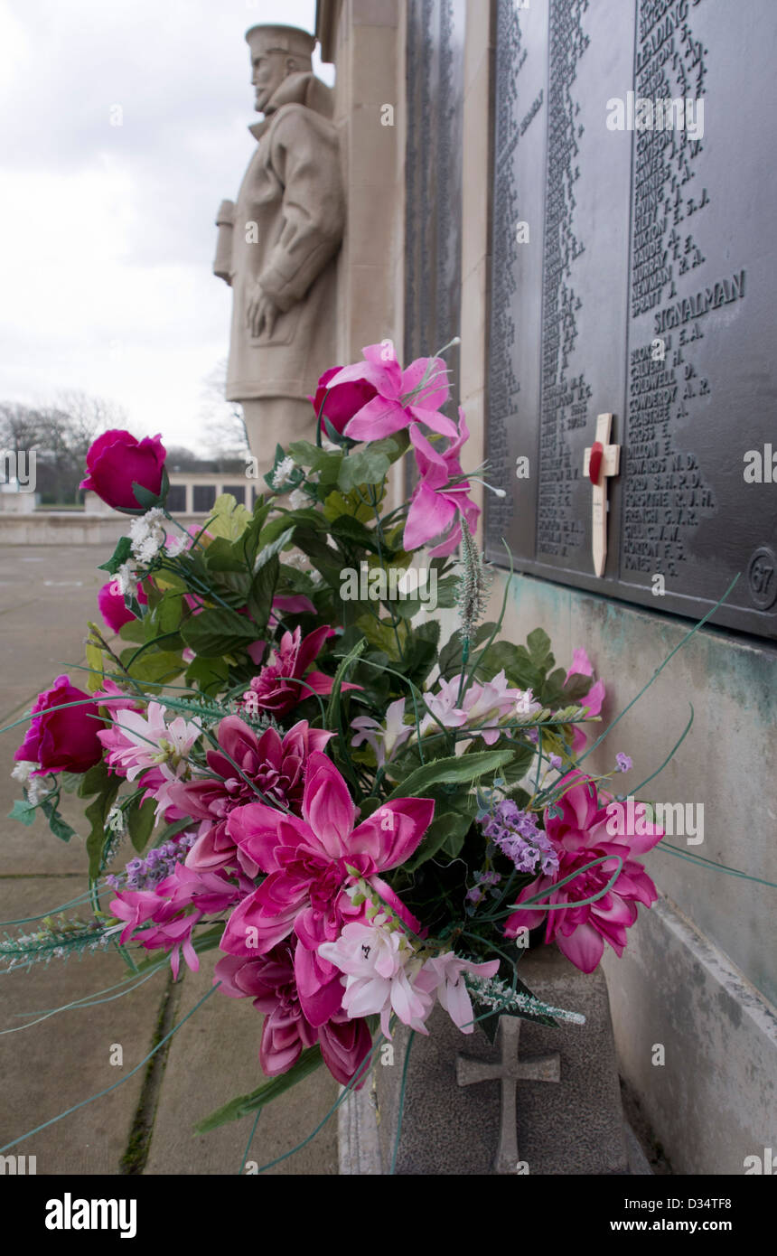 Silk flowers in memorial at Royal Naval War Memorial, Plymouth Hoe, Devon UK Stock Photo