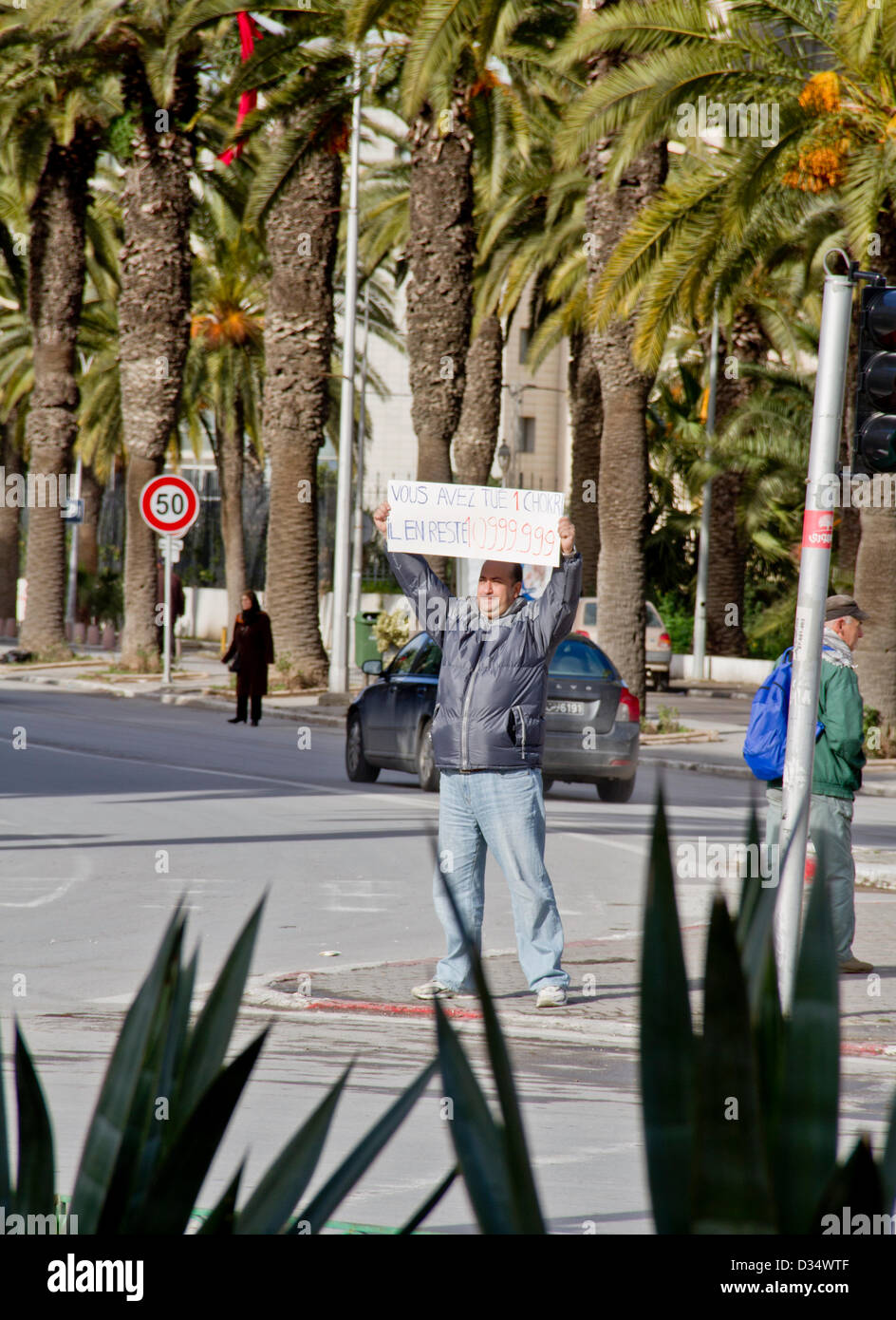 a man holding a sign which reads 'you killed 1 chokri, but there is 10999.999's chokri' during the protests after Tunisian opposition leader Chokri Belaid's murder in Tunis, Tunisia on Friday 08 Feb 2013. Stock Photo