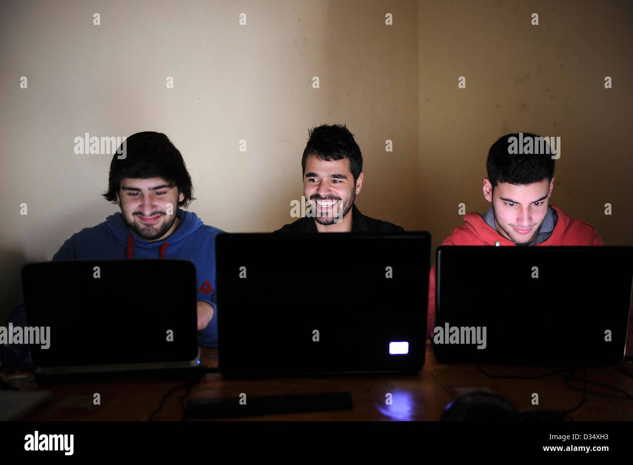 Three young men using laptop computers Stock Photo