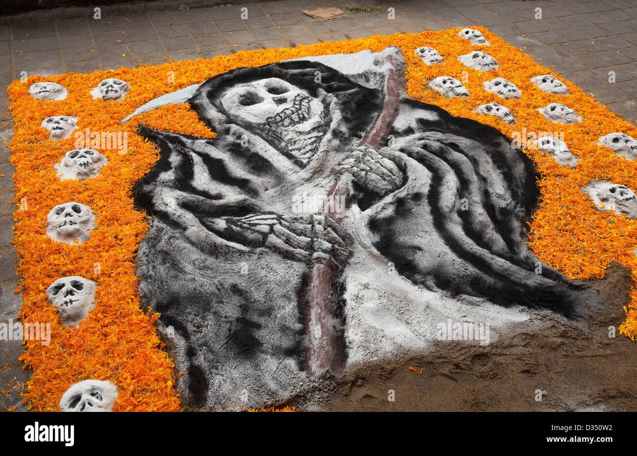 Sand painting of skulls, Grim Reaper, and marigold petals for Day of the  Dead (Dia de los Muertos) festival, Oaxaca, Mexico Stock Photo - Alamy