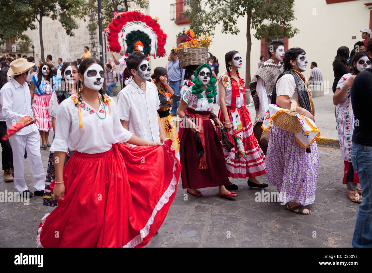 Day of the Dead parade with participants in traditional clothing and spectators in Oaxaca, Mexico. Stock Photo