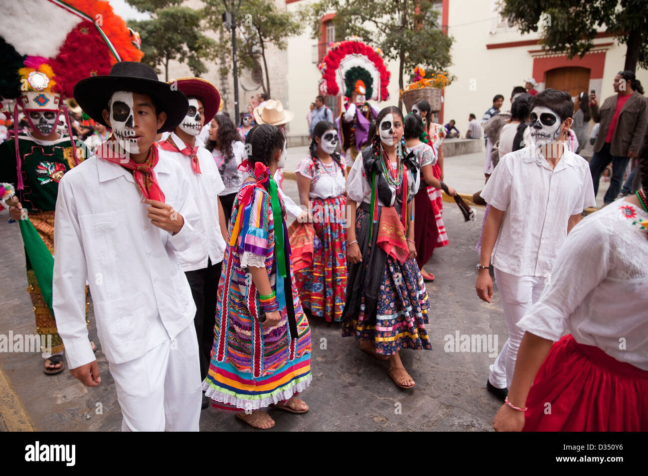 Day of the Dead parade with participants in traditional clothing and spectators in Oaxaca, Mexico. Stock Photo