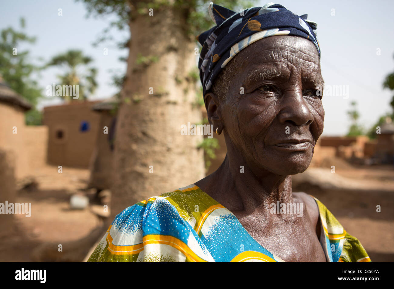 Reo, Burkina Faso, May 2012: Marie Kanyala, 79, in her compound with her Boabab tree. Stock Photo