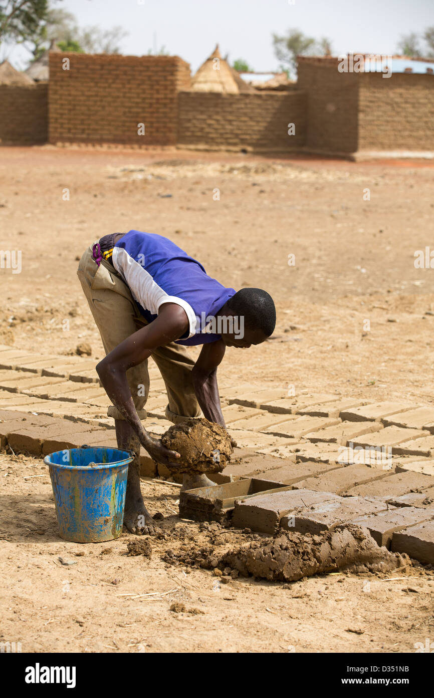 Yako, Burkina Faso, May 2012:  Making bricks to dry in the sun. Stock Photo