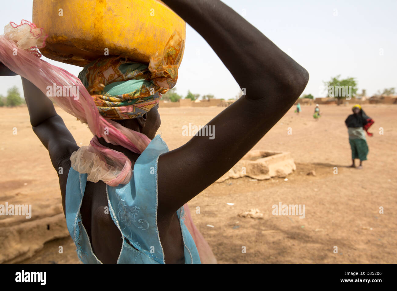 Yako, Burkina Faso, May 2012:  Women fetch water from the village borehole.   Photograph by MIke Goldwater Stock Photo