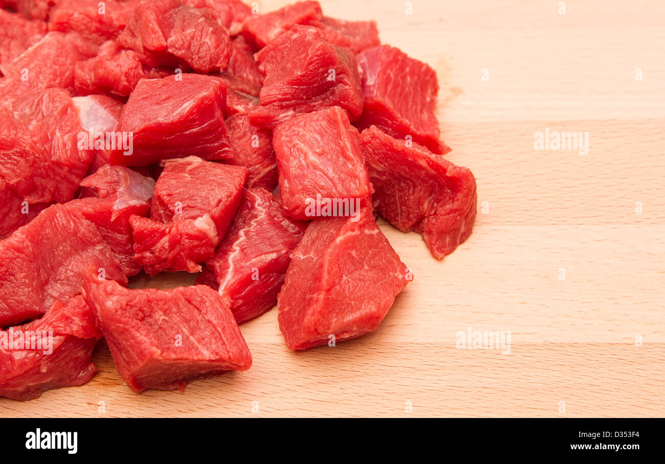 Fresh chopped beef steak on wooden chopping board Stock Photo