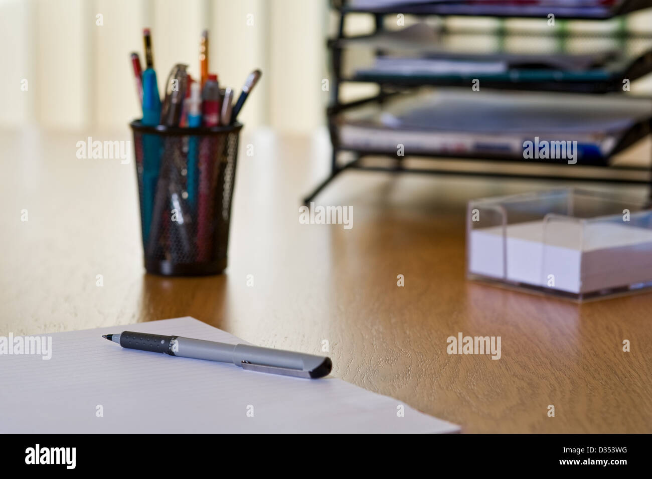 Modern office desk top, with in and out trays.. Stock Photo