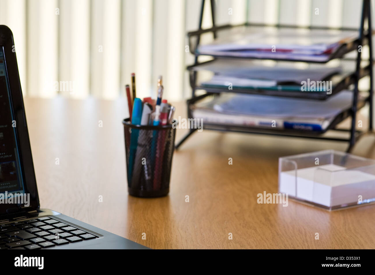 Modern office desk top, with in and out trays.. Stock Photo